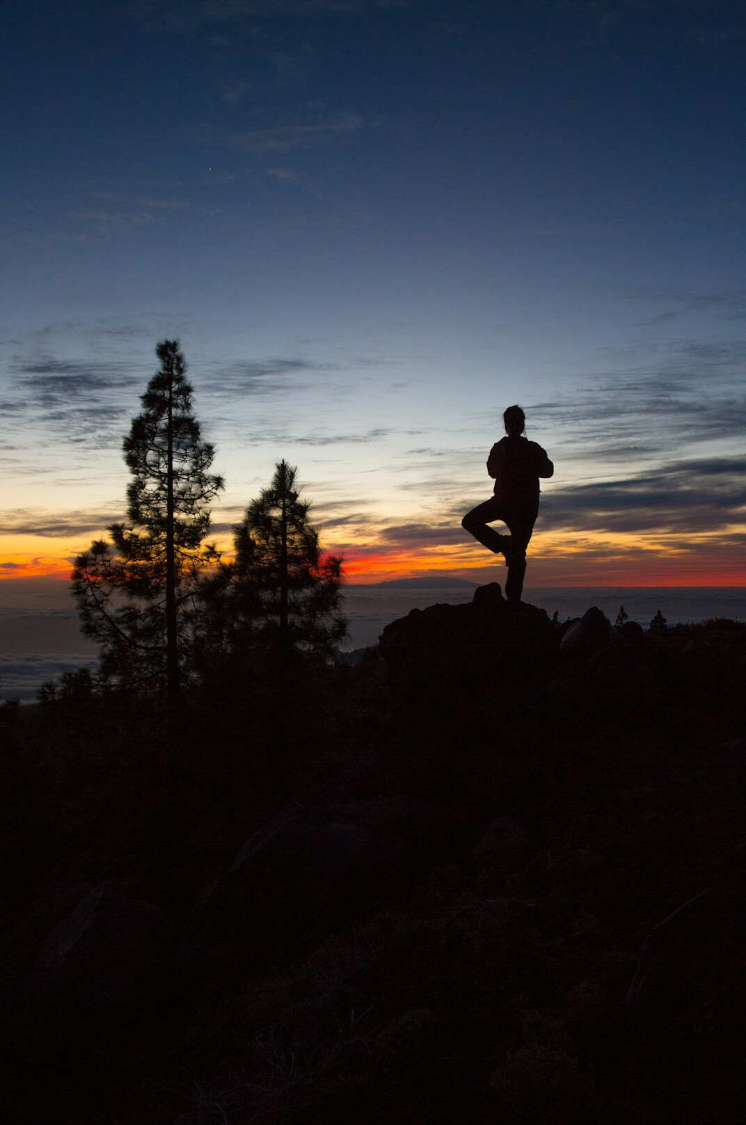 person meditating at sunrise