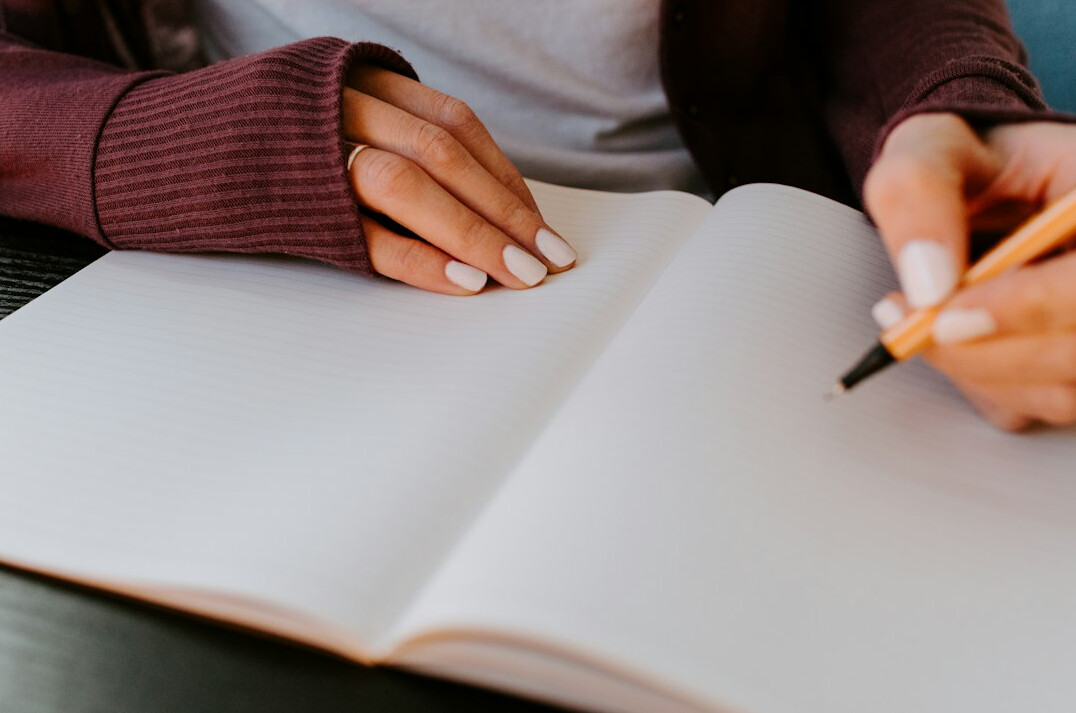 person journaling at desk